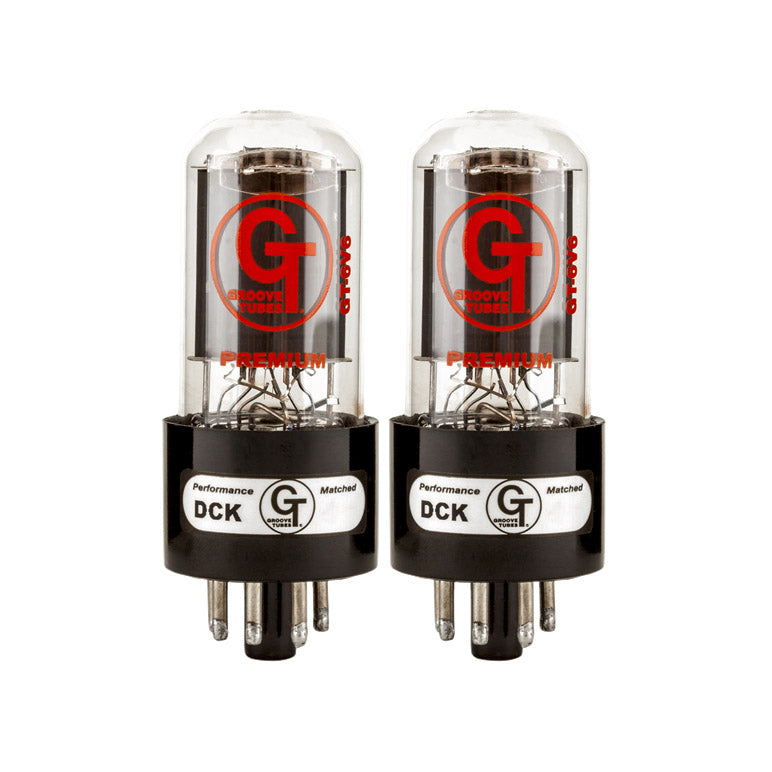 Pair of two clear glass vacuum tubes with black base and metal pins, labeled Groove Tubes Premium Performance DCK Matched.