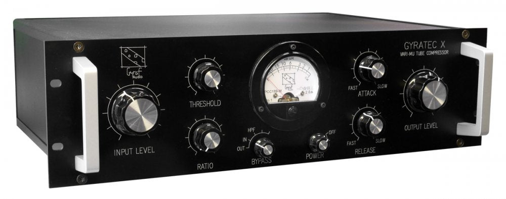 Black audio processor unit with rotary knobs, toggle switches, and an analog meter on front panel.