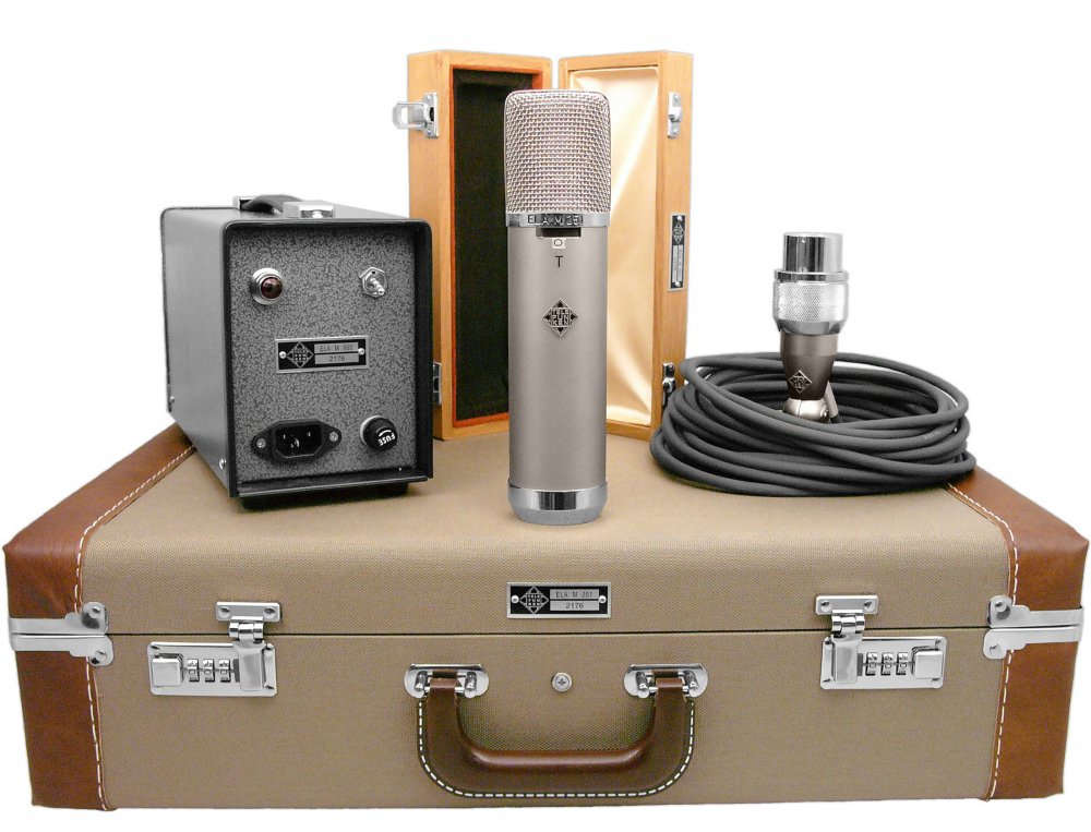 Studio microphone with power supply, audio cable, wooden box, and carrying case displayed on a surface.