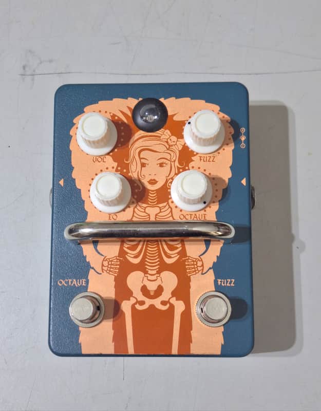 A blue metal Orange Fur Coat guitar effects pedal with four control knobs and two footswitches on a rugged chassis with side-recessed input and output jacks.