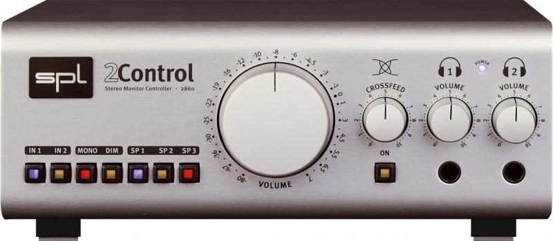 Front view of a silver stereo monitor controller with multiple buttons, three volume knobs, and two headphone jacks.