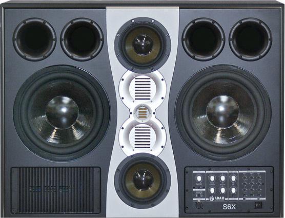 A landscape ADAM Audio S6X active main studio monitor with a horizontally symmetrical seven-driver front baffle: two 12-inch woofers at the left and right edges, paired cone and X-ART ribbon midrange drivers, and an X-ART folded-ribbon tweeter at centre.