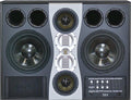 A landscape ADAM Audio S6X active main studio monitor with a horizontally symmetrical seven-driver front baffle: two 12-inch woofers at the left and right edges, paired cone and X-ART ribbon midrange drivers, and an X-ART folded-ribbon tweeter at centre.