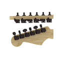 Two views of a set of black guitar tuning pegs installed on natural wood guitar headstocks.