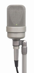 Silver studio microphone with mesh grille and attached cable on a stand mount