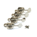Four silver metal bass guitar machine heads with washers and mounting screws on a white background