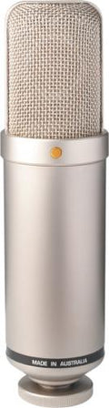 Silver cylindrical microphone with a mesh grille and a gold dot on the front, made in Australia.