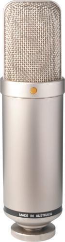 Silver cylindrical microphone with a mesh grille and a gold dot on the front, made in Australia.