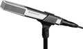 Black and silver microphone mounted on a stand with an XLR cable connected.