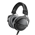 Black and gray over-ear headphones with cushioned ear pads and a wired cable connected at one ear cup.