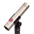 Silver cylindrical microphone with black mount and a red logo, shown at an angled view.