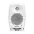 White Genelec studio monitor speaker with front grille, brand logo, green indicator light, and a stand.
