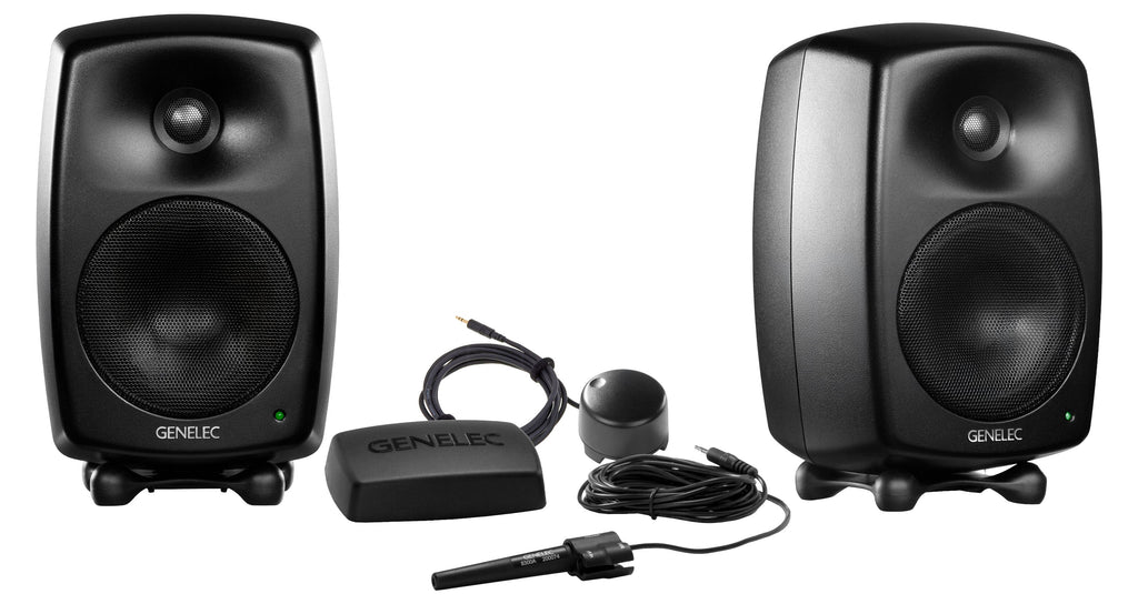 Two black studio monitor speakers with Genelec branding and calibration microphone with accessories on white background.