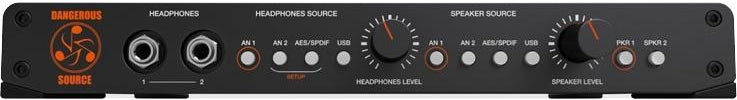 Black audio monitor controller with headphone jacks, multiple input source toggles, and level knobs.