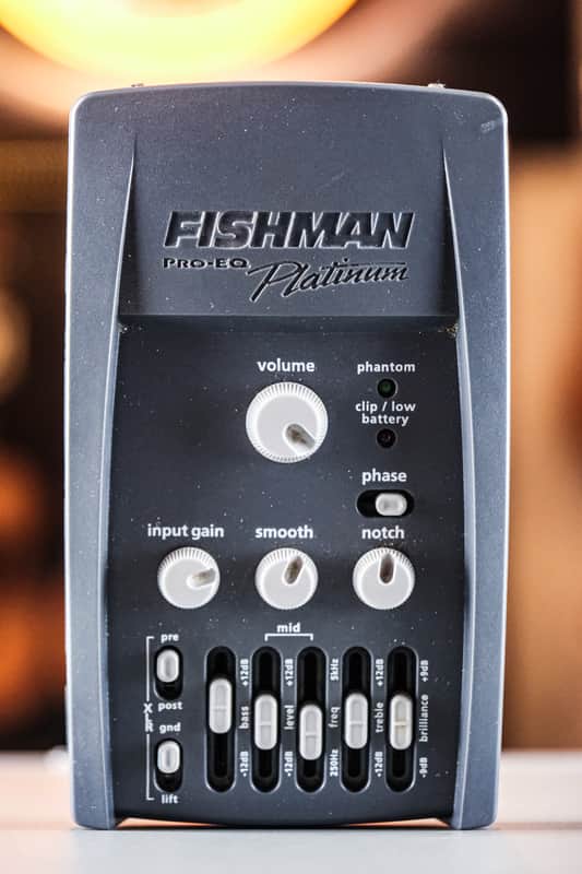 Grey Fishman Pro EQ Platinum equalizer pedal with knobs, sliders, and switches for volume, gain, and tone adjustment.