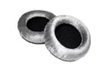 Pair of gray fabric and foam ear pads with black inner mesh for headphones.