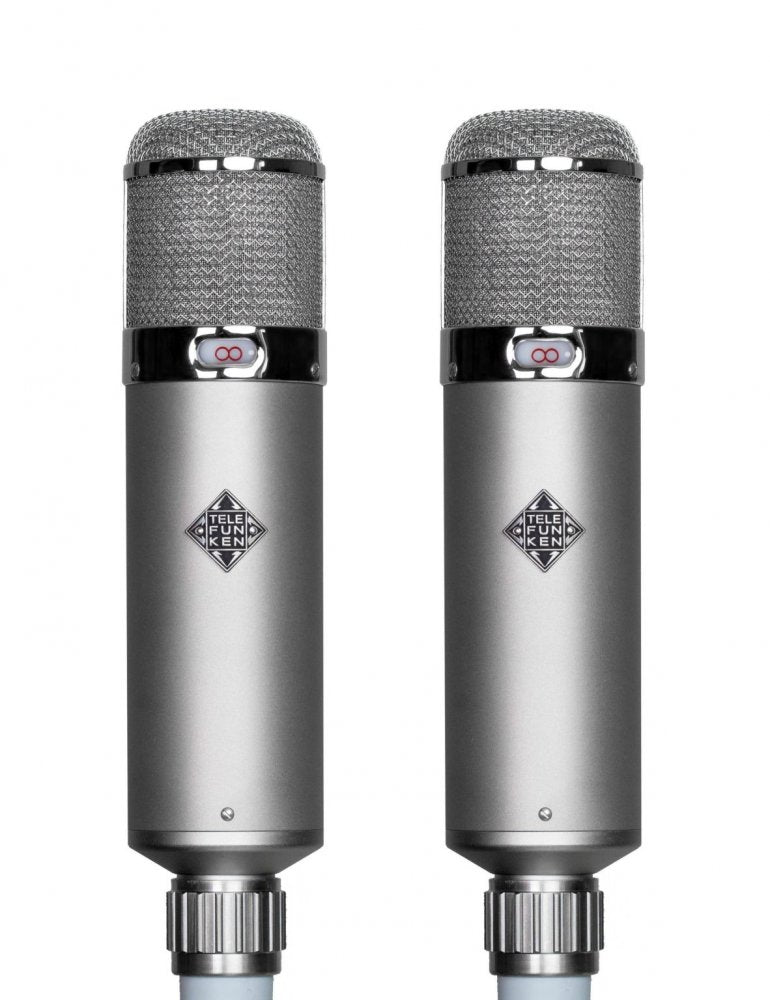 Matched pair of TELEFUNKEN U48 large-diaphragm tube condenser microphones, each a long cylindrical body with grille headbasket and red polar-pattern badge, shown with dual power supply and included accessories.