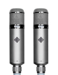 Pair of silver cylindrical microphones with mesh grille and TELEFUNKEN logos on the bodies.