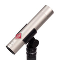 Silver cylindrical microphone with black mount and red logo on a white background.