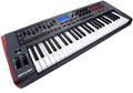 Black and white MIDI controller keyboard with 61 keys, knobs, pads, faders, buttons, and a blue LED screen.