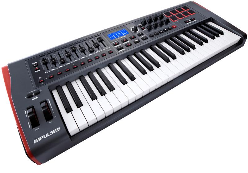 Black and white MIDI controller keyboard with 61 keys, knobs, pads, faders, buttons, and a blue LED screen.