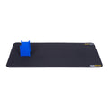 Black rectangular mat with two MusicNomad logos and a blue plastic stand or support piece attached on one end.