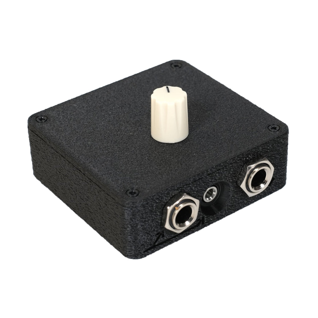 Small black rectangular device with a white rotary knob and two 1/4 inch jack sockets on one side