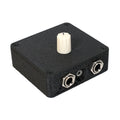 Small black rectangular device with a white rotary knob and two 1/4 inch jack sockets on one side