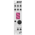White modular synthesizer module with multiple jacks, a knob, a button, and a small screen showing 'MCO'.