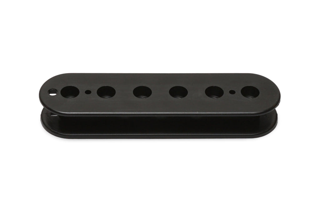 Black plastic pickup bobbin with six holes lined in a row, viewed from the front.