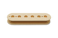 Vintage cream colored plastic pickup bobbin with six round holes and two smaller holes in a single row.