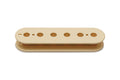 Cream-colored pickup bobbin with six circular holes for pole pieces, viewed from above.