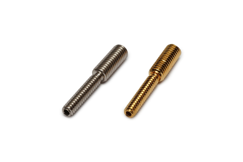 Two threaded metal posts in silver and gold finishes on a white background.