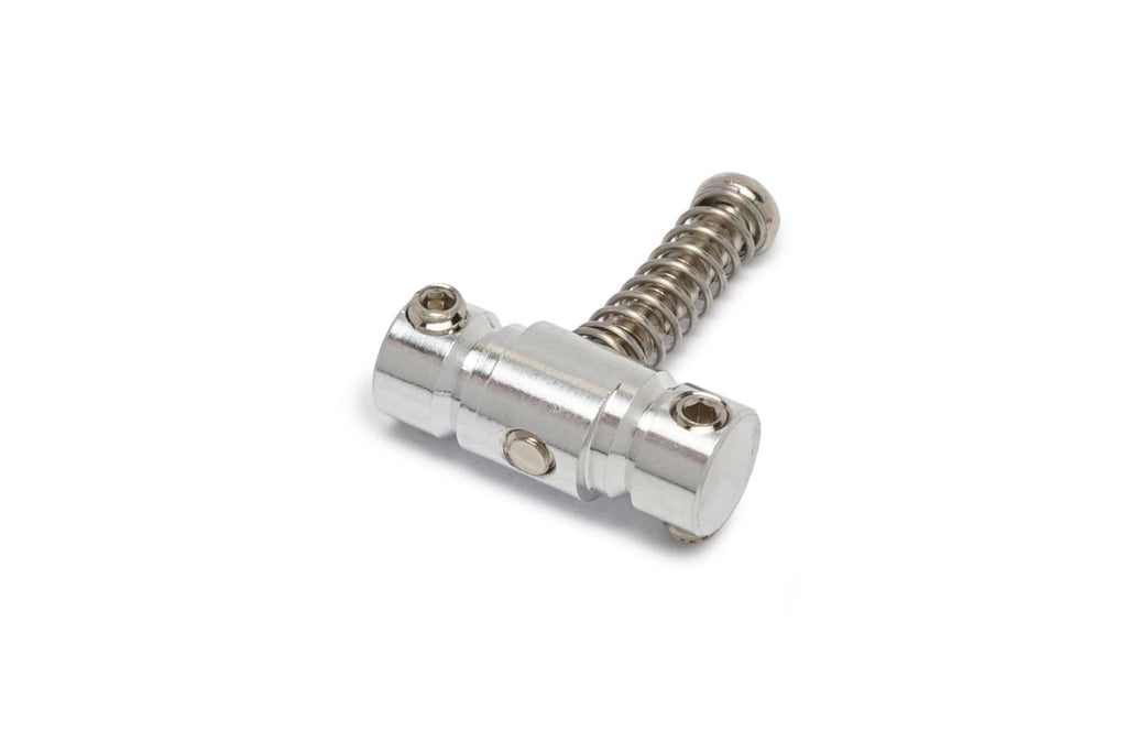Metal component with two hex screws and a spring, possibly a guitar saddle part, on a white background.