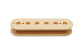 Cream-colored plastic pickup bobbin with seven holes, viewed from the side on a white background.