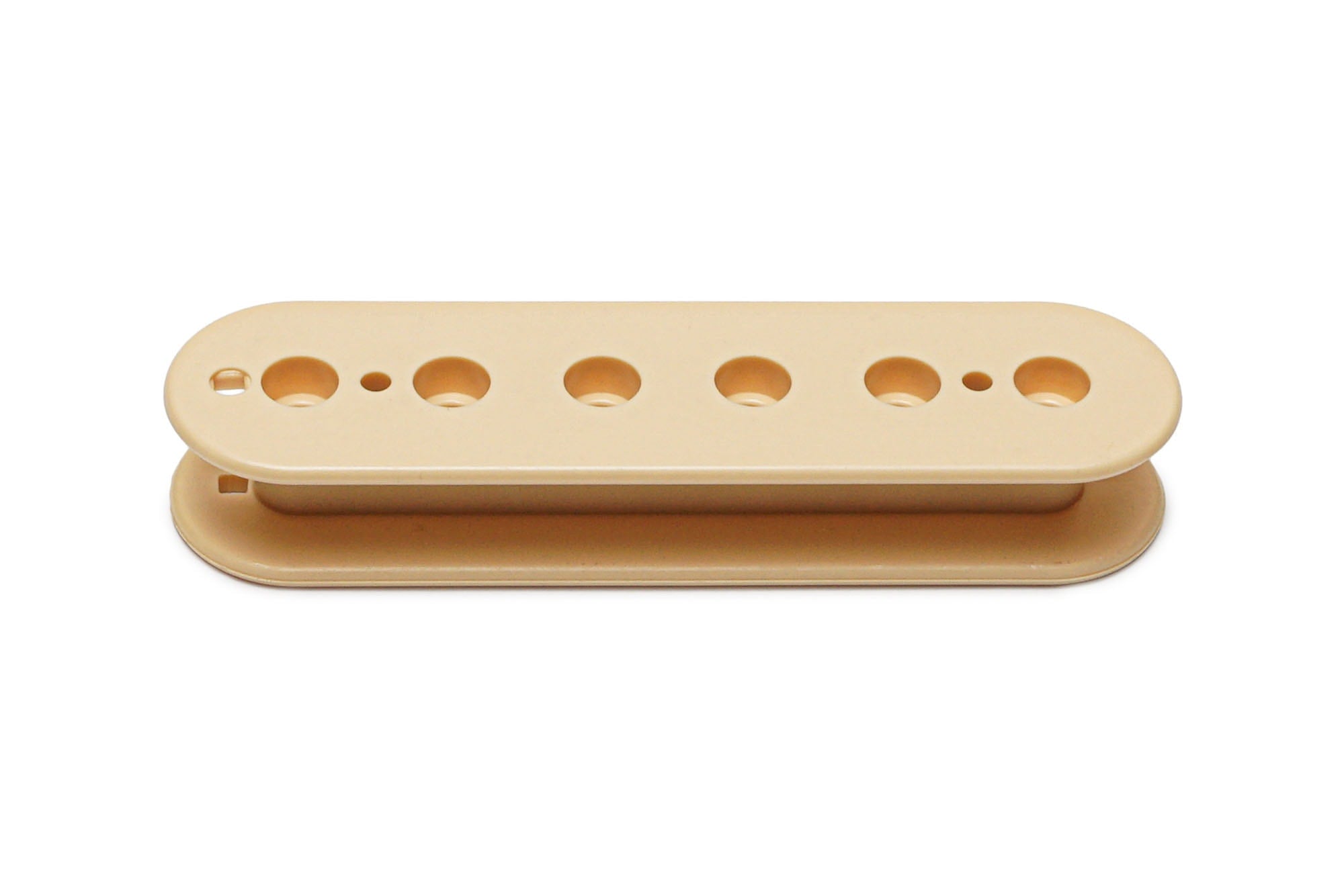 Cream-colored plastic pickup bobbin with seven holes, viewed from the side on a white background.