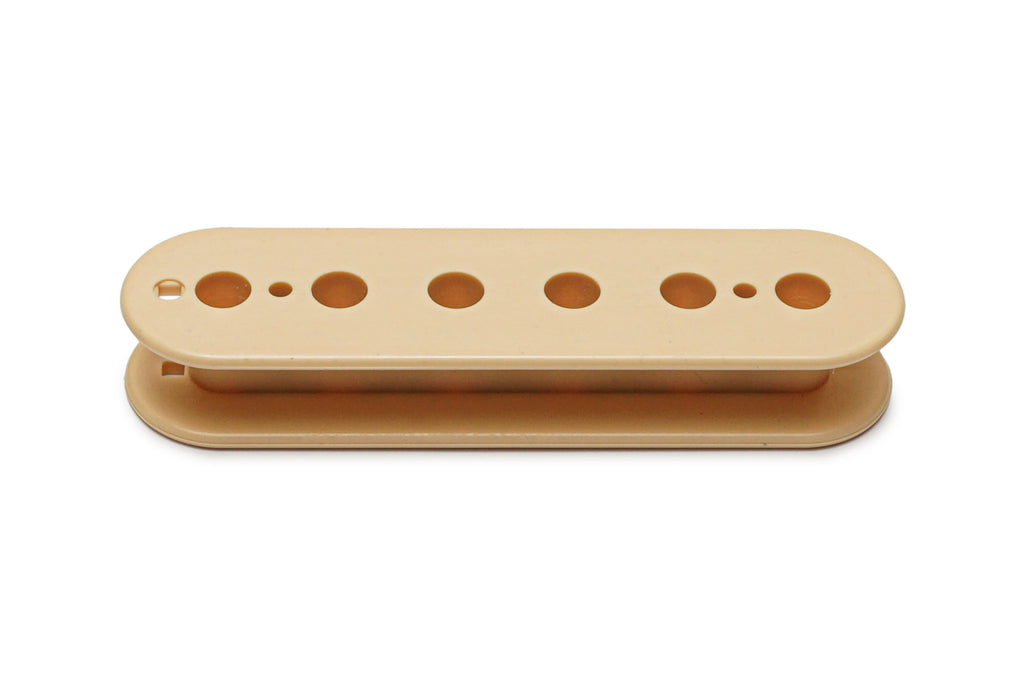 Cream-colored plastic guitar pickup bobbin with multiple circular holes for magnets or pole pieces.