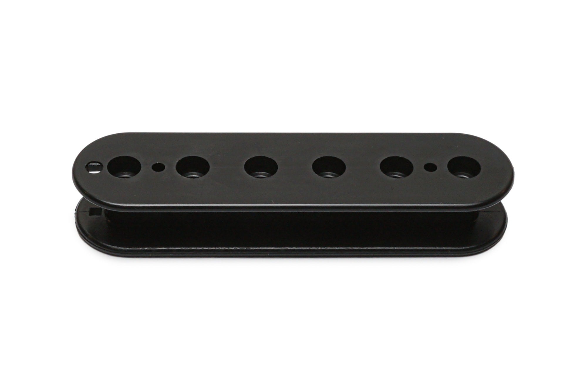 Black plastic pickup bobbin with six circular holes and two smaller holes arranged in a row.
