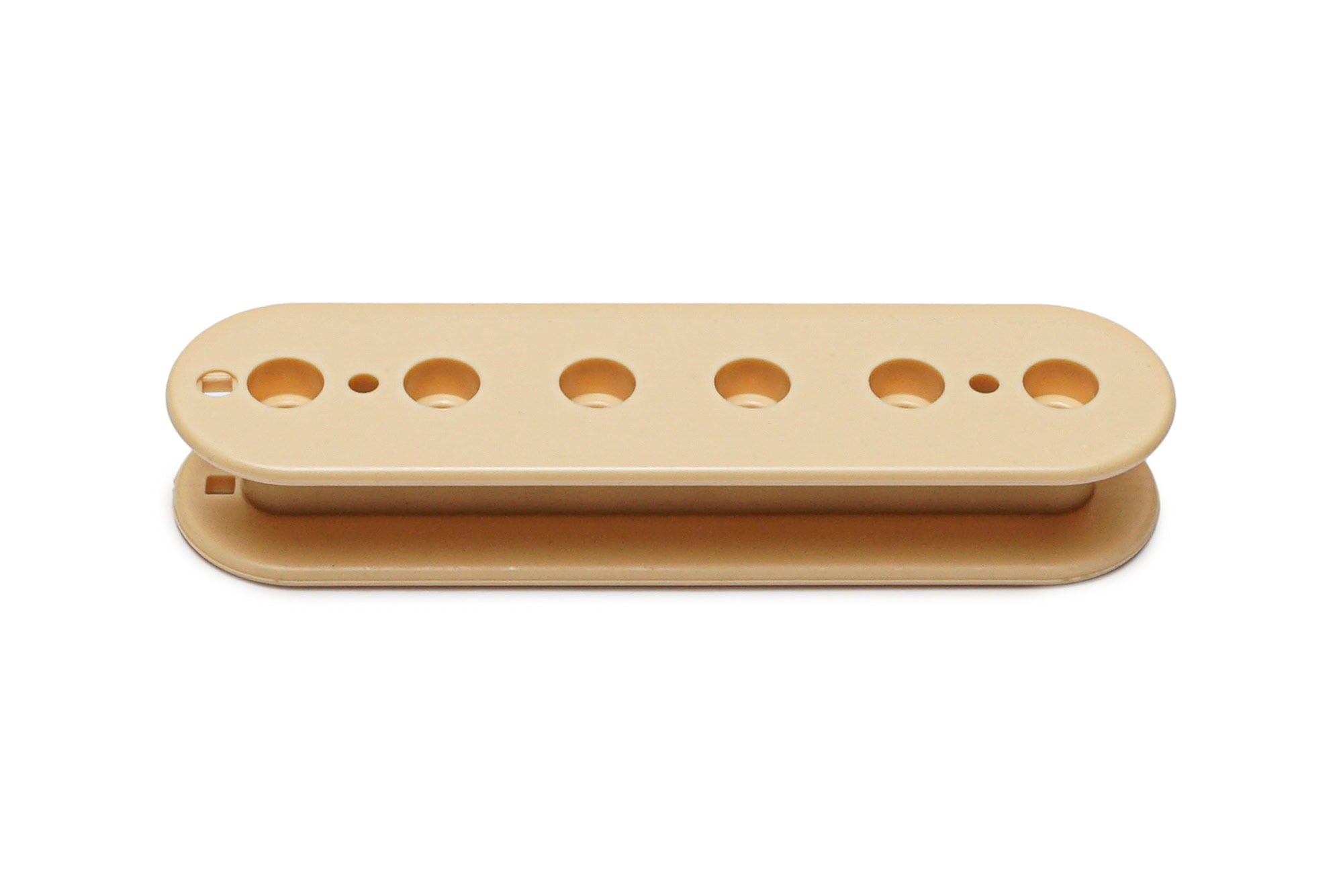 Cream-colored plastic pickup bobbin with six holes and two smaller holes on a white background.