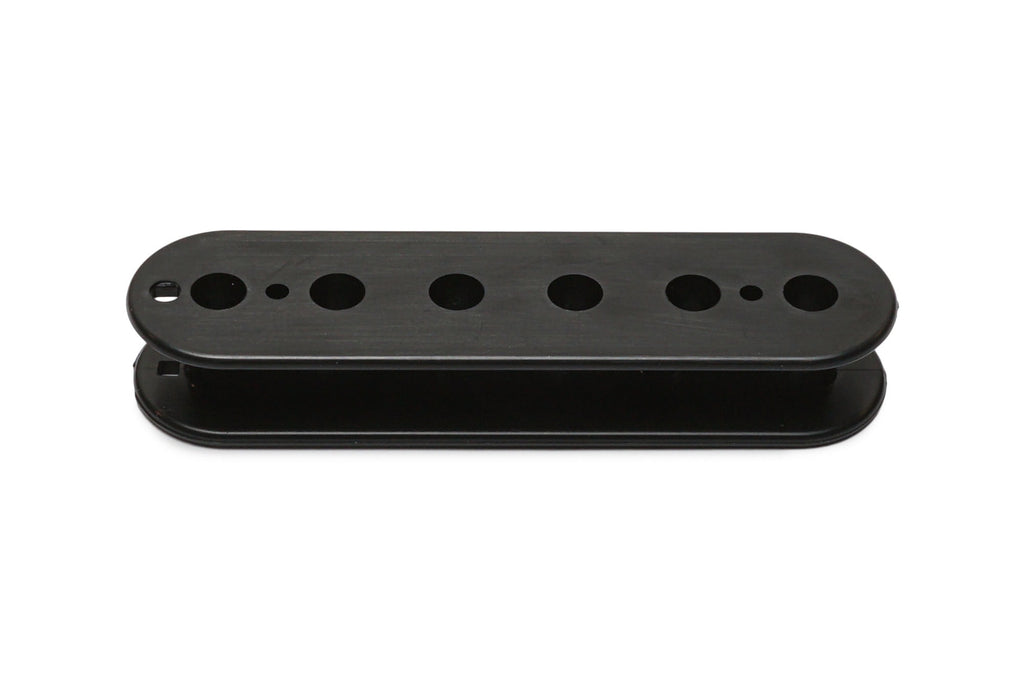 Black elongated plastic pickup bobbin with multiple circular holes arranged in a row.