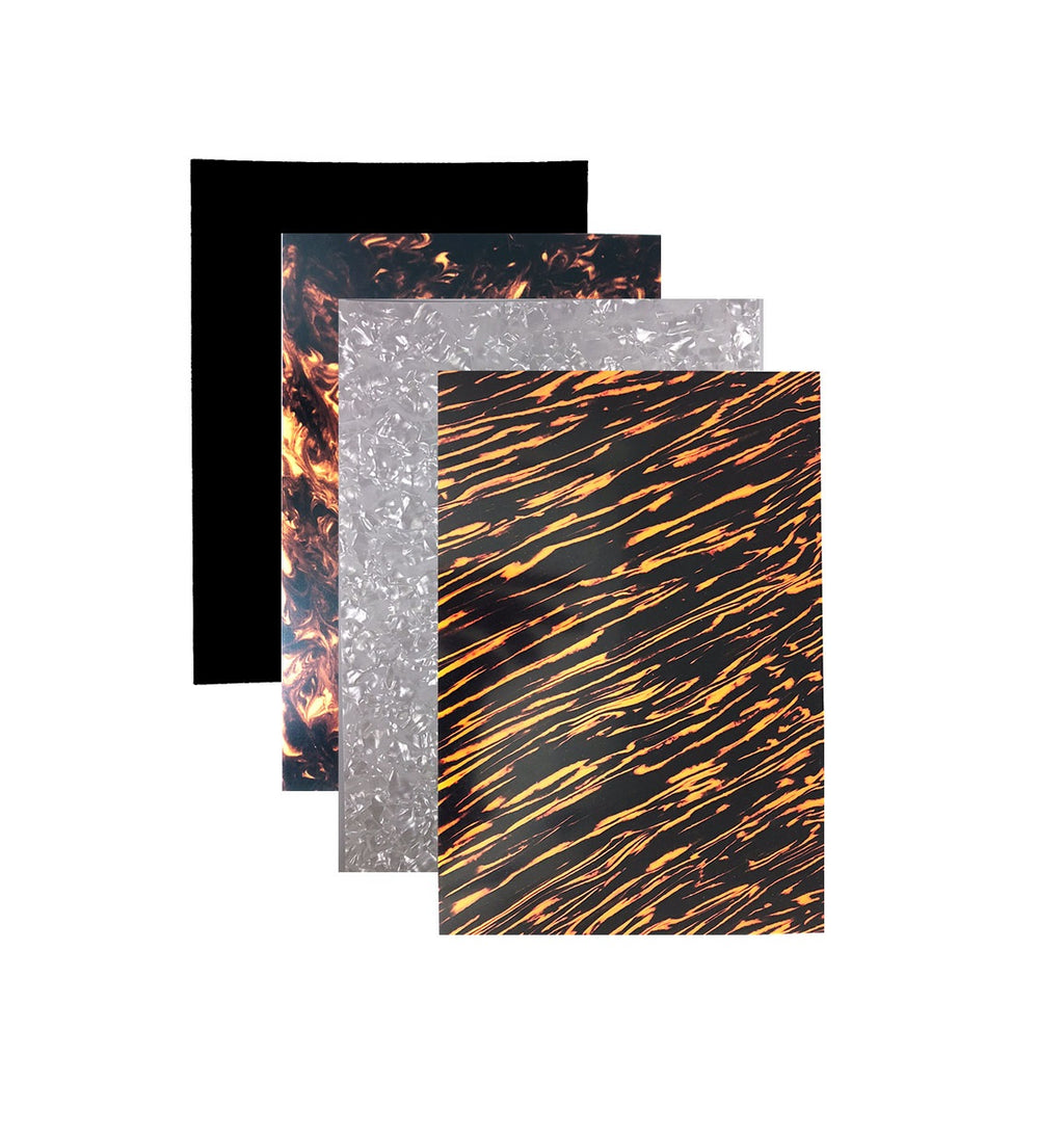Four rectangular plastic sheets with different decorative patterns arranged overlapping on white background.
