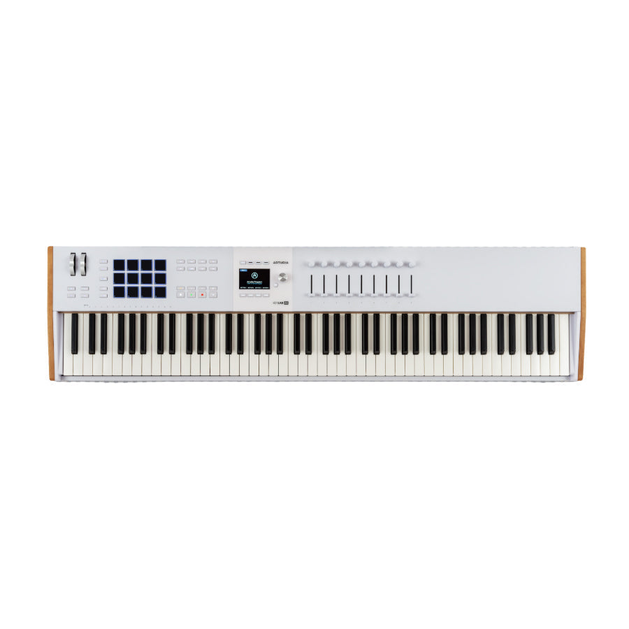 White MIDI keyboard controller with 88 keys, pads, knobs, sliders, and a small display screen.