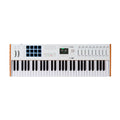 White MIDI keyboard controller with pads, knobs, sliders, and display screen.