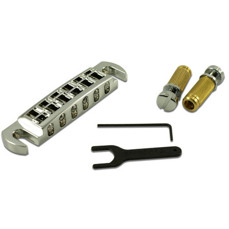 Chrome wraparound guitar bridge with two threaded posts, wrench, and hex key on a white background.