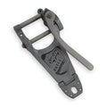 Metal vibrato unit with lever arm and patent information embossed on its surface.
