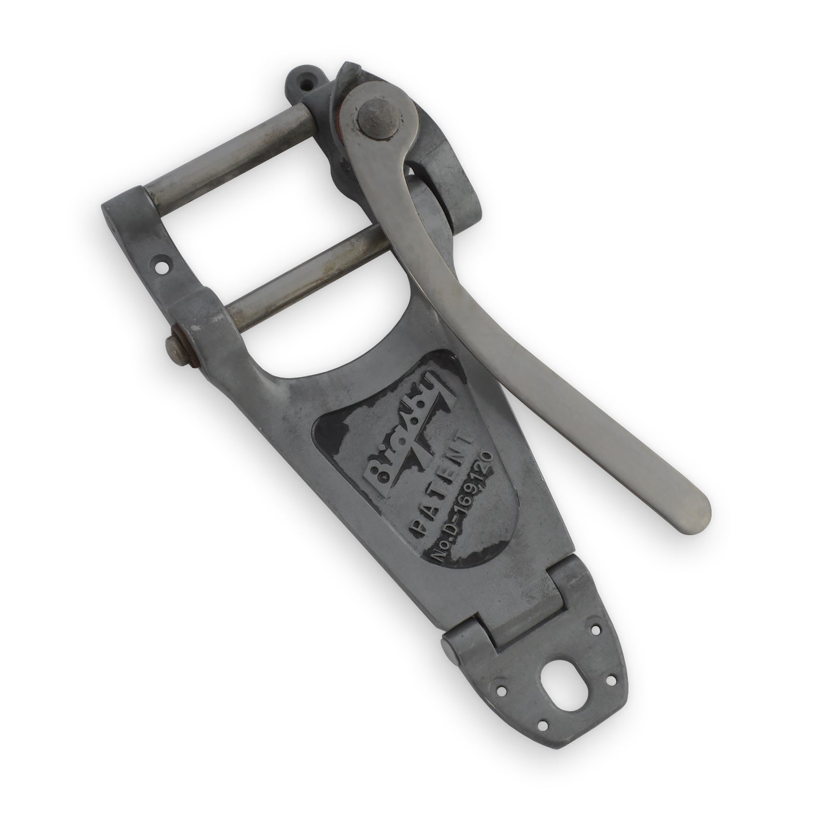 Metal vibrato unit with lever arm and patent information embossed on its surface.