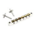 Metal guitar bridge with brass saddles and two threaded adjustment screws on a white background.