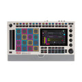 Top view of a white Akai MPC Live III music production center with colored pads, buttons, knobs, and a screen.