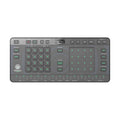 Top view of a compact music synthesizer controller with buttons, pads, and a small display screen.