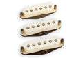 Three cream-colored single coil guitar pickups with black rusty mounting bases on a white background.